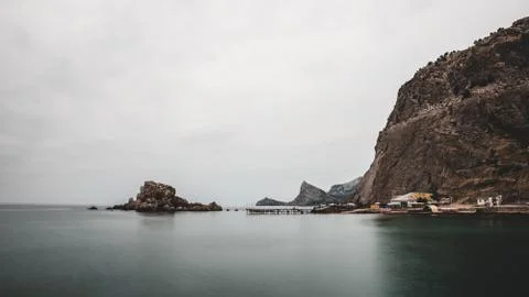 Mountain at the flat sea Stock Photos