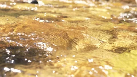 Mountain flowing water, close-up, defocused background, bokeh effect Stock Footage 136511178