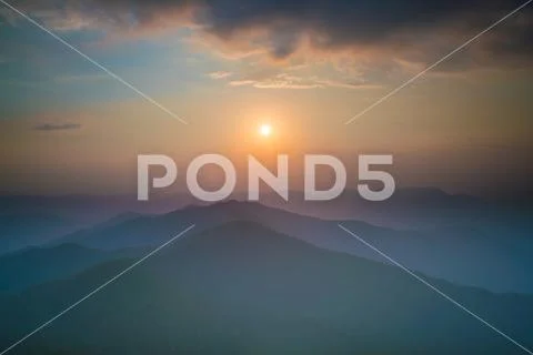 The mountain in the fog on the background of sunset, Wide angle Stock Photos