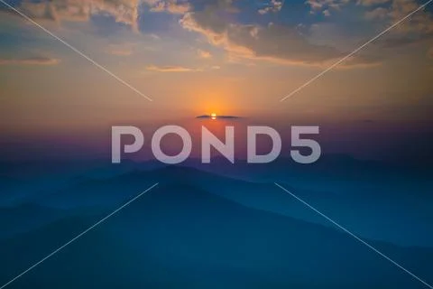 The mountain in the fog on the background of sunset, Wide angle Stock Photos