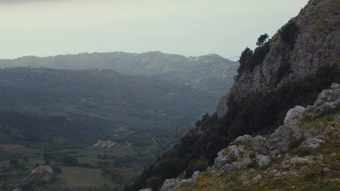 A mountain in the foreground and small houses in the background Stock Footage 88718282