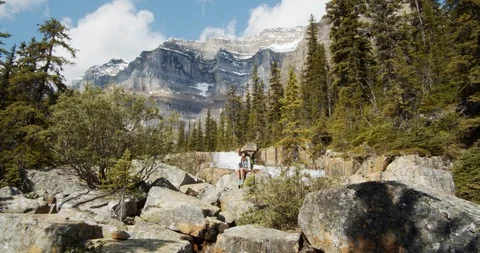 Mountain Forest with Clouds, Stream and Woman Waiving at Camera Video stock 121689337