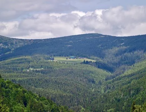 Mountain forest landscape with cloudy sky over green valley Stock Photos
