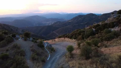 Mountain forest path revealing plains, ridges and old wooden power poles Stock Footage 321613201