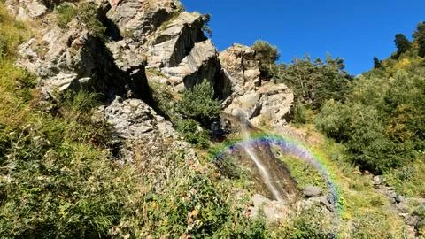 Mountain forest water cascade with rainbow at summer, sightseer adventure Stock-Fotos