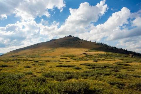 Mountain in the form of a triangle. Blue sky. Stock Photos