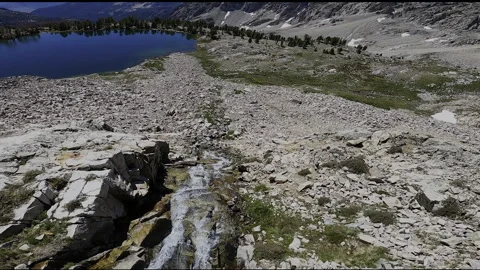 Mountain FPV Drone Dive: High Peaks to Alpine Lake Descent Stock Footage 331897016