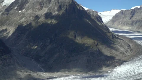 Mountain in the Great Aletsch Glacier, with cloud shadow of  Stock Footage 194487498