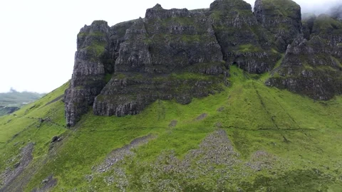 A mountain with a green grassy slope Stock Footage 306619992