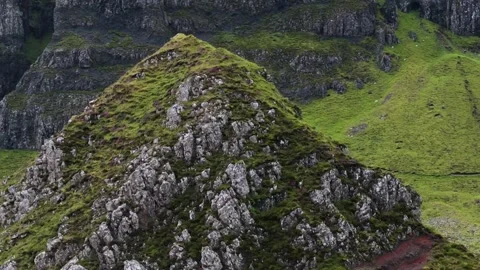 A mountain with a green hillside coming into view Stock Footage 306419152