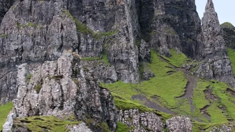 A mountain with a green hillside Stock Footage 306418282