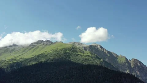 Mountain green meadows against the background of blue sky and clouds Stock Footage 166548489