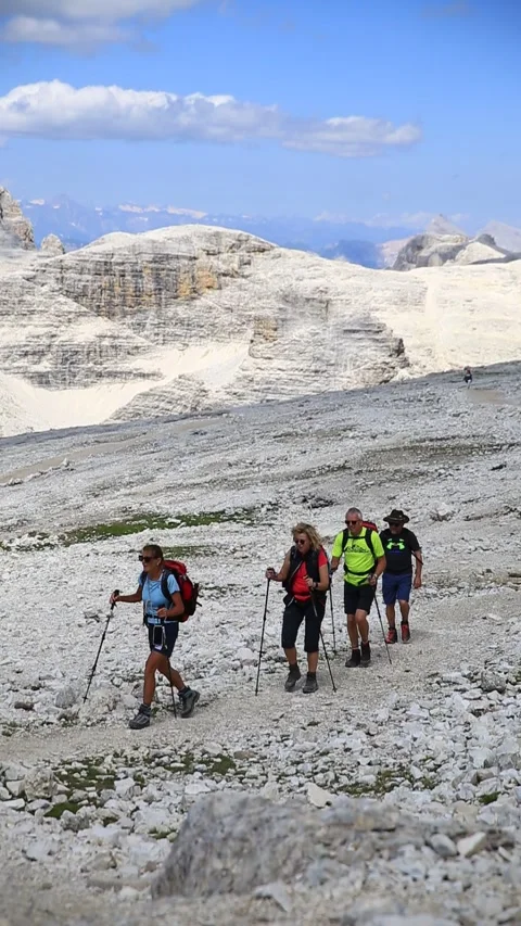 Mountain guide with three tourists hiking on Piz Boè, moon-like surface 動画素材 284462999