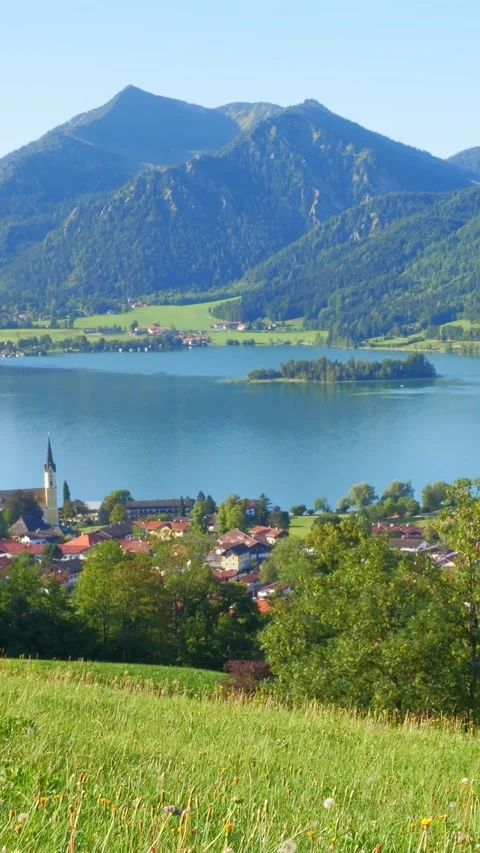 Mountain harmony and lakeside tranquility in Neuhaus with open skies, wildflo Stock Footage 308306587