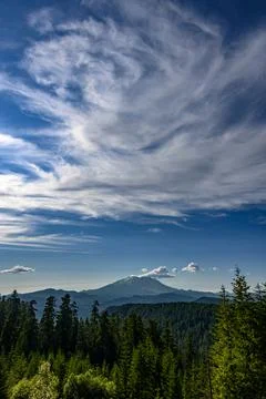 Mountain Helen view with dramatic clouds above forest landscape during dayt.. Stock Photos