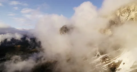 Mountain hidden in thick clouds in the Dolomites. Aerial of beautiful Sunset Stock Footage 132107828