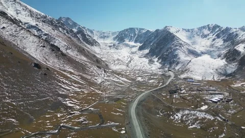 Mountain Highway Leading into Snow-Covered Tian Shan, Kyrgyzstan Stock Footage 340922067