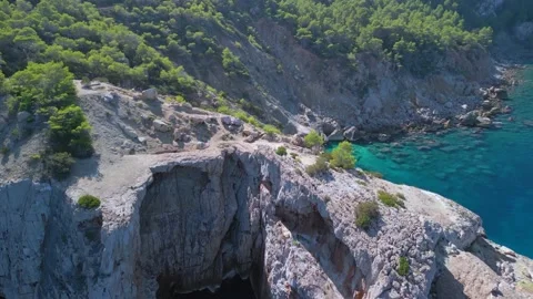 Mountain hike cliff edge Breathtaking aerial view flight drone ibiza Aubarca bay Stock Footage 229032700