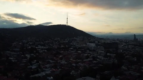 Mountain Hill Overlooking Tbilisi at Sunset With Warm Light Across Distant City Stock Footage 320398567