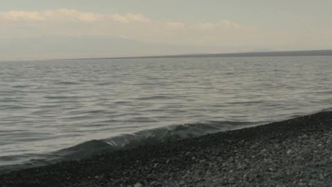 Mountain Horizon over Pebbled Shore Stock Footage 342035315