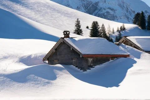 Mountain hut in the snow Stock Photos