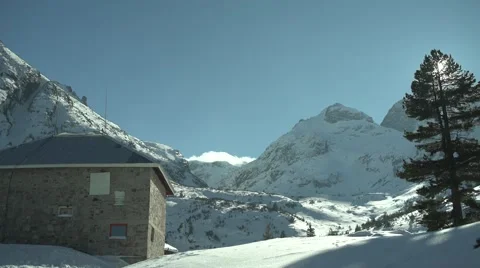 Mountain Hut to Snowy High Peaks Panning 4K Stock Footage 59776326