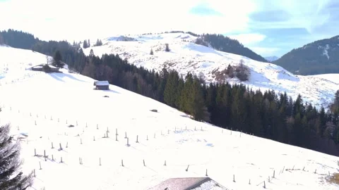 Mountain huts in the midst of winter silence: small wooden buildings lost among  Stock Footage 303305040
