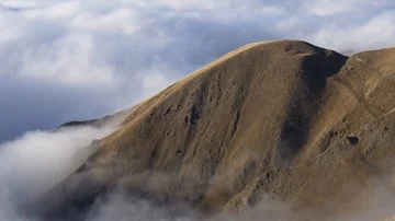 Mountain as an island in the clouds Stock Footage 85725281