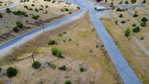 Mountain junction with ski center parking and dry alpine terrain in Greece Stock Footage 321892774