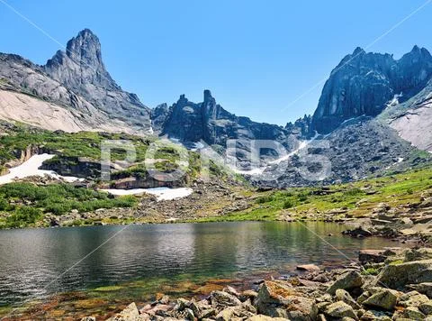 Mountain lake against backdrop of ridge. June. Ergaki. Krasnoyarsk region. Ru Stock Photos