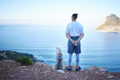 Mountain, lake and back of man with dog for hiking, walking and fresh air Stock Photos