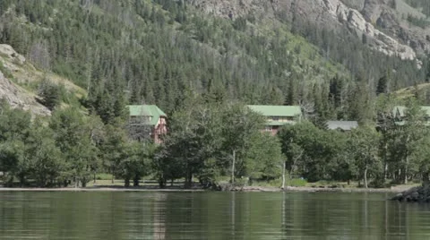 Mountain Lake with Cabins in Background Stock Footage 22018514