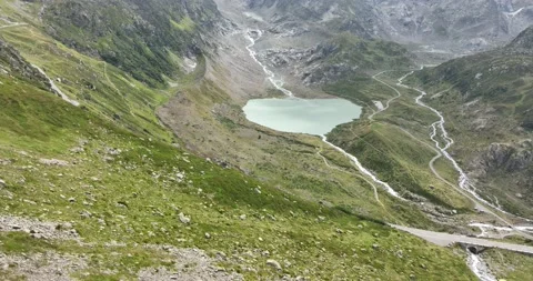 Mountain lake called the Steinsee on top of the Sustenpass in Switzerland Stock Footage 229764734