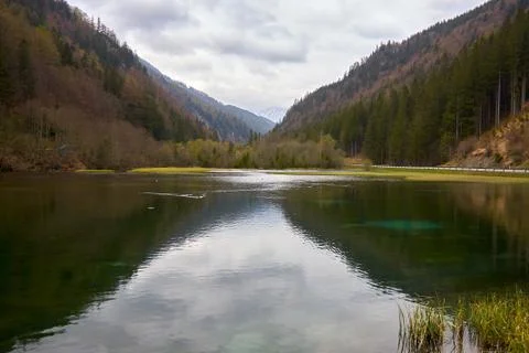 Mountain lake with cloud reflection in the mountains of the alps Stock Photos