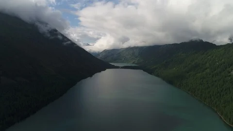 Mountain lake with forest and clouds Stock Footage 108029783