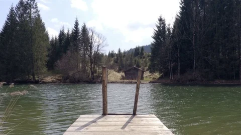 Mountain Lake with the house on the background in spring time Stock Footage 74660561