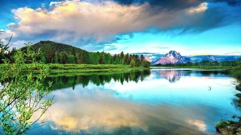 Mountain Lake Landscape with Forest Reflection and Dramatic Sky Stock Photos