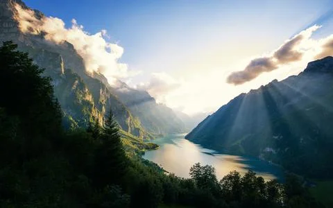 Mountain Lake Panorama with Sun Rays and Alpine Valley Stock Photos