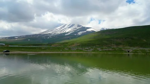 Mountain Lake Reflection Under Dramatic Clouds Stock Footage 337100391