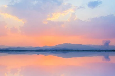 Mountain in lake at sunset with reflection Stock Photos