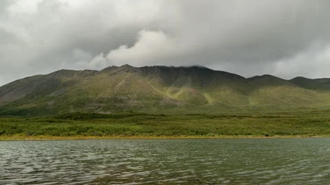 Mountain lake under storm clouds in Alaska timelapse Stock-Footage 348019630