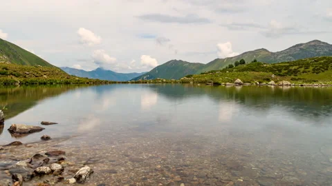 Mountain lake view and cloud reflections Stock Footage 147643812