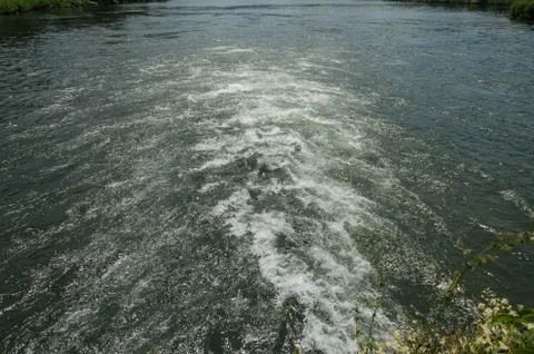 The mountain lake into which the river flows Stock Photos