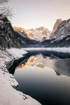 Mountain lake in Winter with Reflection during Sunset Stock Photos