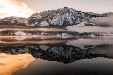 Mountain lake in Winter with Reflection during Sunset Stock Photos
