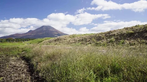 Mountain with Land Field, Clouds and Blue Sky during before Autumn Season. Stock Footage 128943351