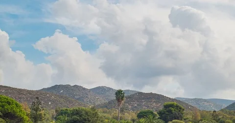Mountain landscape and clouds. Palms and trees. Timelapse Stock Footage 82370474