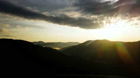Mountain landscape in the backlight. Bright white sky on silhouettes of high Stock Footage 165856135