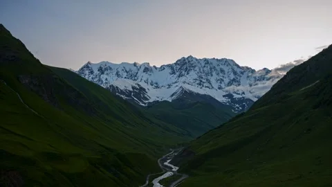 Mountain landscape bathed in the soft light of either dawn or dusk. Stock Footage 297848764