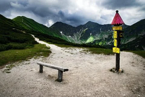 Mountain landscape with a bench and a pointer Foto stock